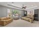 Spacious bedroom features seating area, large windows, and a ceiling fan at 6315 Carol Butte Ct, Las Vegas, NV 89141
