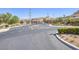 Gated community entrance with desert landscaping, street and Highland Hills sign at 6315 Carol Butte Ct, Las Vegas, NV 89141