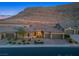 Single-story home with a courtyard, a three-car garage, and desert landscaping at 6315 Carol Butte Ct, Las Vegas, NV 89141