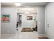 Inviting foyer with tile flooring, elegant lighting, and a view into a home office and living spaces at 6315 Carol Butte Ct, Las Vegas, NV 89141
