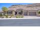 Charming single-story home featuring desert landscaping, tile roof, and attached two-car garage at 6315 Carol Butte Ct, Las Vegas, NV 89141