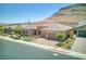 Desert home featuring lovely landscaping, large garage, and beautiful mountain backdrop at 6315 Carol Butte Ct, Las Vegas, NV 89141