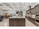Gourmet kitchen with stainless steel appliances, island with bar seating, and gray cabinetry at 6315 Carol Butte Ct, Las Vegas, NV 89141