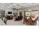 Spacious living area with a cozy fireplace, comfortable seating, and a dining space with backyard views at 6315 Carol Butte Ct, Las Vegas, NV 89141