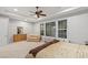 Bright main bedroom featuring large windows and a ceiling fan at 6315 Carol Butte Ct, Las Vegas, NV 89141