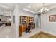 Home office featuring a built-in bookcase, ample lighting, and a view into the main living area at 6315 Carol Butte Ct, Las Vegas, NV 89141