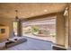 Inviting covered patio with ceiling fan, lounge furniture, and serene backyard fountain view at 6315 Carol Butte Ct, Las Vegas, NV 89141