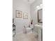 Clean powder room featuring framed art, a pedestal sink, and tiled floors at 6315 Carol Butte Ct, Las Vegas, NV 89141