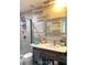 Bathroom with wood-like tile walls, updated vanity, framed mirror, and glass shower featuring a mosaic tile floor at 6441 Brushwood Ln, Las Vegas, NV 89107