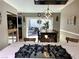 The dining area features a wooden table, contemporary light fixture, and sliding glass doors leading to the outdoor patio at 6441 Brushwood Ln, Las Vegas, NV 89107