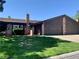 Charming single-story home with brick accents, a well-manicured lawn, and a two car garage at 6441 Brushwood Ln, Las Vegas, NV 89107