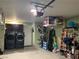 Organized garage with washer, dryer, and plenty of storage space for tools and other household items at 6441 Brushwood Ln, Las Vegas, NV 89107