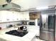 Modern kitchen with white cabinetry, quartz countertops, and stainless steel appliances at 6441 Brushwood Ln, Las Vegas, NV 89107