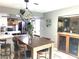 Stylish kitchen featuring a wooden dining table, bar stool seating, and modern light fixture at 6441 Brushwood Ln, Las Vegas, NV 89107