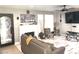 Comfortable living room with a white brick fireplace, ceiling fan, and wood-look flooring at 6441 Brushwood Ln, Las Vegas, NV 89107