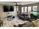 Comfortable living room with a ceiling fan, light grey walls and wood-look flooring at 6441 Brushwood Ln, Las Vegas, NV 89107