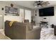 Comfortable living room with a white brick fireplace, ceiling fan, and wood-look flooring at 6441 Brushwood Ln, Las Vegas, NV 89107
