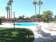 Community pool with ample lounge space and tall palm trees, ideal for relaxing and enjoying the sun at 6441 Brushwood Ln, Las Vegas, NV 89107