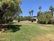View of community pool area with lawn, trees, and comfortable seating, perfect for relaxation at 6441 Brushwood Ln, Las Vegas, NV 89107