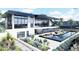 Modern two-story home featuring an outdoor pool, deck, and professionally landscaped grounds at 645 Dragon Peak Dr, Henderson, NV 89012