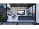 Open-concept flex room with a modern kitchen, large TV, comfortable seating, and outdoor access at 645 Dragon Peak Dr, Henderson, NV 89012