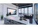 Bright flex room boasting a kitchen island, seating, large windows, and stunning mountain views at 645 Dragon Peak Dr, Henderson, NV 89012