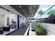 Relaxing covered lower patio with seating area and lush landscaping at 645 Dragon Peak Dr, Henderson, NV 89012