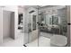 Luxurious main bath with glass-enclosed shower, soaking tub, and modern fixtures at 645 Dragon Peak Dr, Henderson, NV 89012