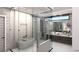Contemporary main bath featuring a soaking tub, glass shower, and stylish vanity at 645 Dragon Peak Dr, Henderson, NV 89012