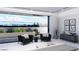 Bright main bedroom featuring a private balcony, stylish seating, and serene views at 645 Dragon Peak Dr, Henderson, NV 89012