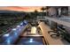 Luxury outdoor space with a large pool, cozy seating, fireplace, and breathtaking city views at 645 Dragon Peak Dr, Henderson, NV 89012