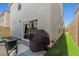 Low maintenance backyard features artificial turf and a covered grill area by the sliding glass door at 6964 Caldera St, Las Vegas, NV 89149