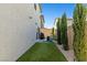 Large backyard features artificial turf, tall trees and a patio near the sliding glass door at 6964 Caldera St, Las Vegas, NV 89149