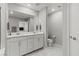 Well-lit bathroom with double vanity, stylish mirrors, and tiled flooring offers a fresh aesthetic at 6964 Caldera St, Las Vegas, NV 89149