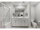 Stylish bathroom features double vanity, glass shower, toilet, and tiled flooring for a modern touch at 6964 Caldera St, Las Vegas, NV 89149