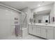 Modern bathroom features double sink vanity, glass enclosed shower, and neutral walls at 6964 Caldera St, Las Vegas, NV 89149