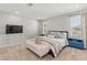 Cozy bedroom features natural light, neutral walls, carpet flooring, and a comfy bed with throw pillows at 6964 Caldera St, Las Vegas, NV 89149