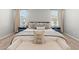 Comfortable bedroom with a well-made bed, soft neutral color pallet, and great natural light at 6964 Caldera St, Las Vegas, NV 89149