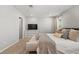 Cozy bedroom featuring a large bed, a TV, lots of pillows, and neutral tones at 6964 Caldera St, Las Vegas, NV 89149