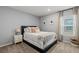 Cozy bedroom with a comfortable bed, side table, and a large window that floods the room with light at 6964 Caldera St, Las Vegas, NV 89149