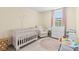 A cozy Bedroom with a crib, comfortable chair, and natural light at 6964 Caldera St, Las Vegas, NV 89149