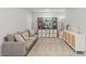 A bonus room features a gray sofa, modern cabinet, and stylish decor at 6964 Caldera St, Las Vegas, NV 89149