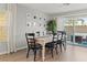 Dining area with a large wooden table, seating for eight, and access to the backyard patio at 6964 Caldera St, Las Vegas, NV 89149