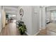 Bright entryway showcases hardwood floors, a console table, and a seamless transition to the dining area at 6964 Caldera St, Las Vegas, NV 89149