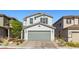 Exterior view of a charming two-story home with a well-manicured front yard and two-car garage at 6964 Caldera St, Las Vegas, NV 89149