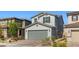 Attractive two-story home with a paved driveway, attached two-car garage, and well-maintained landscaping at 6964 Caldera St, Las Vegas, NV 89149