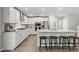 Modern kitchen featuring stainless appliances, granite countertops, island seating, and ample cabinet space at 6964 Caldera St, Las Vegas, NV 89149