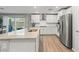 Contemporary kitchen features stainless steel appliances, granite countertops, open layout, and backyard access at 6964 Caldera St, Las Vegas, NV 89149