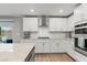Bright kitchen featuring stainless steel appliances, granite countertops, and backyard access at 6964 Caldera St, Las Vegas, NV 89149