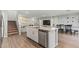 Open-concept kitchen with stainless steel appliances, granite countertops, and seamless flow to dining area at 6964 Caldera St, Las Vegas, NV 89149
